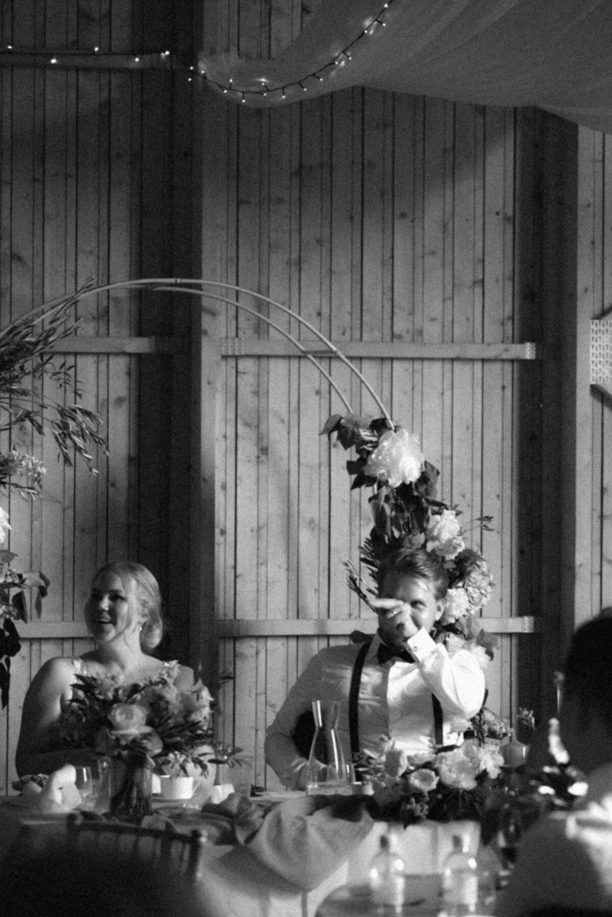 The groom is communicating with someone  in an image photographed by wedding photographer Hannika Gabrielsson.