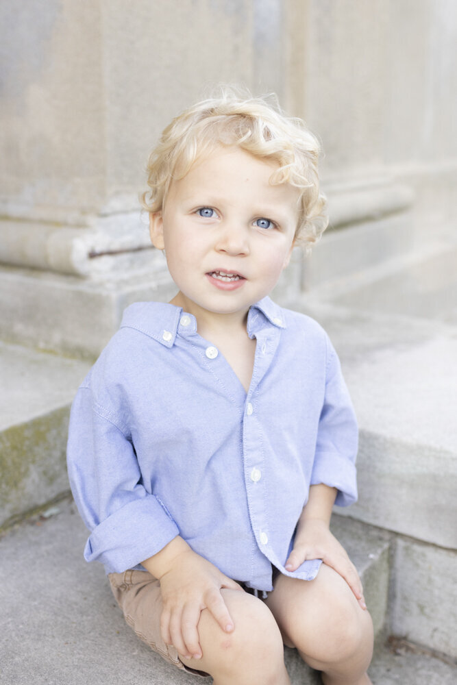 portrait of toddler boy in blue shirt