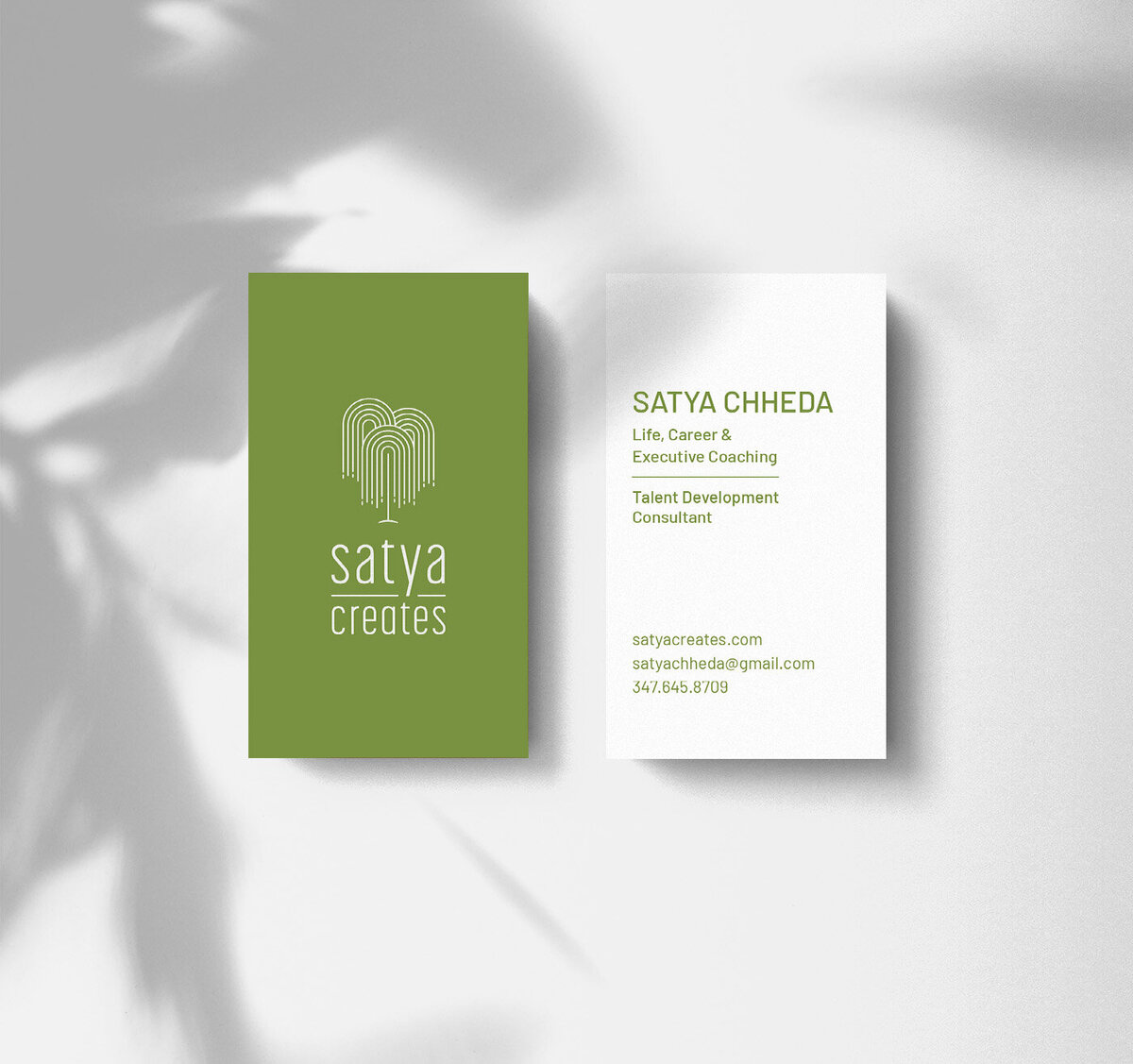 Two Satya Creates business cards. The one on the left shows the front and the one on the right shows the back
