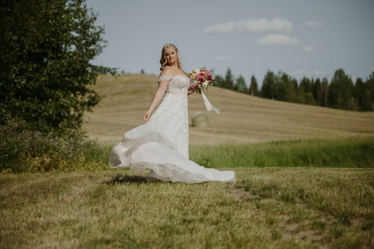 bride with bouquet in alberta field