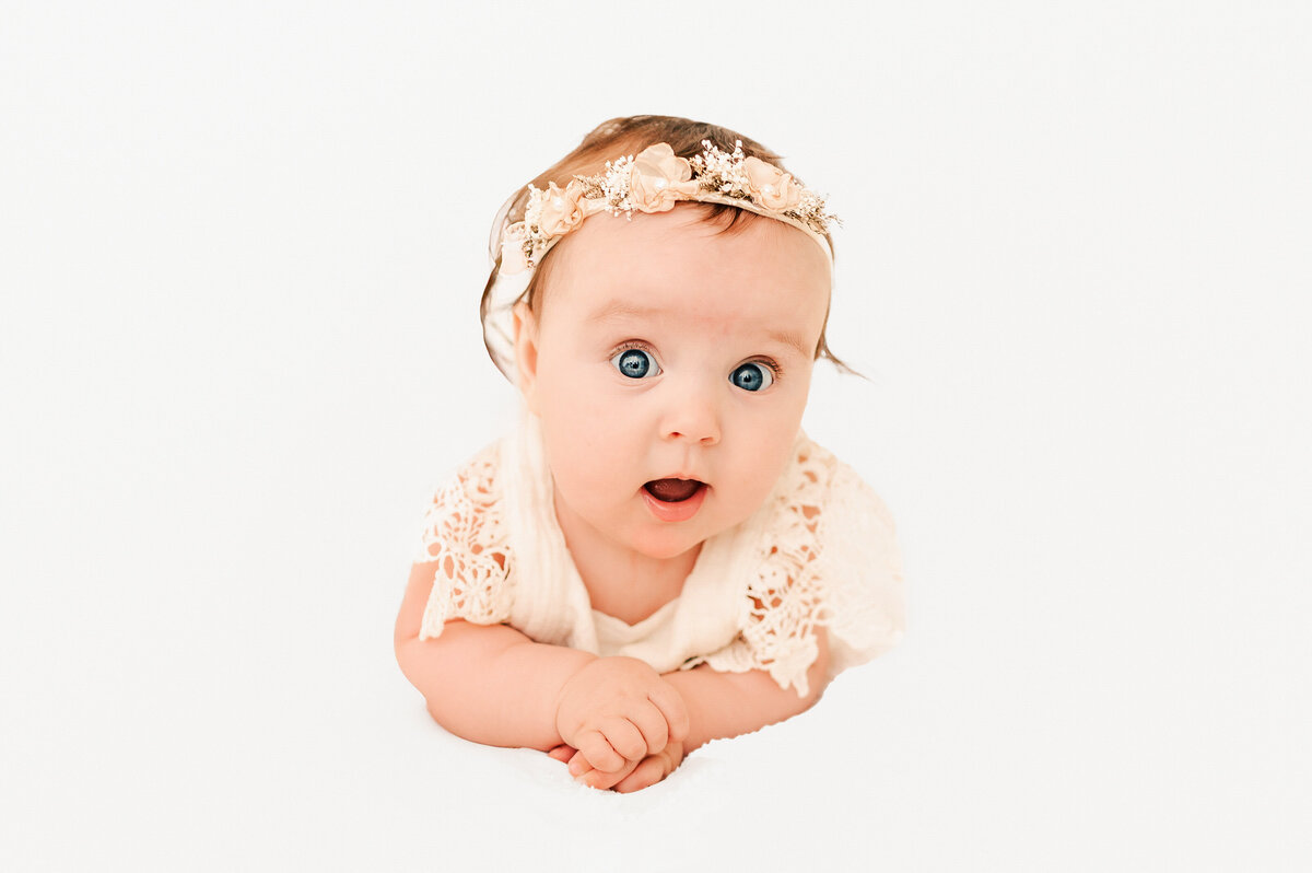Springfield MO kids photography of baby laying on belly smiling in The XO Photography studio