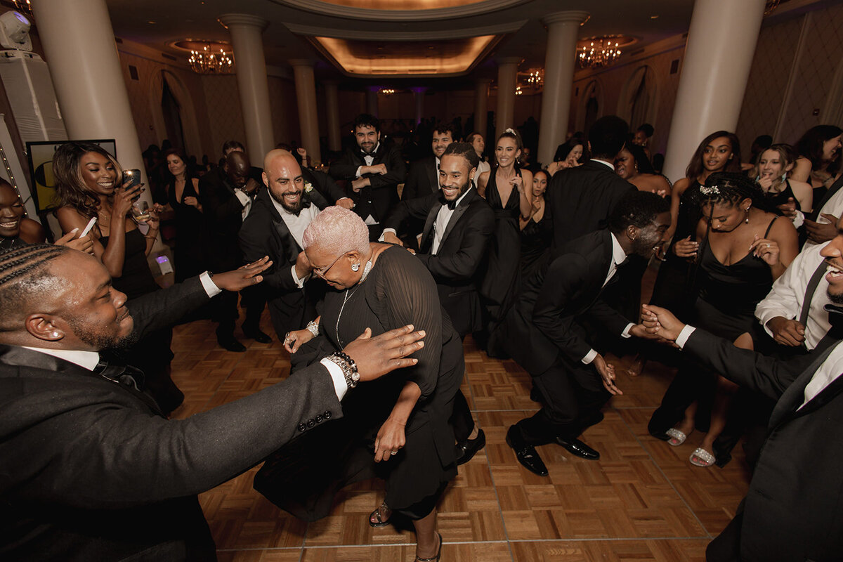 black grandmother dancing at wedding reception everyone clapping