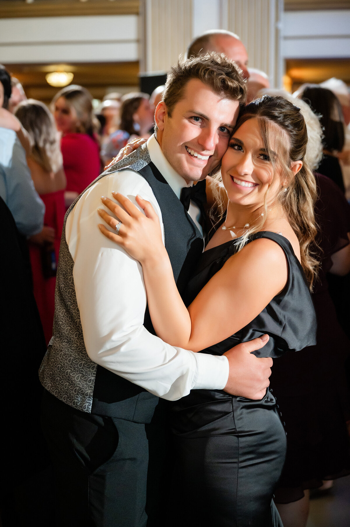 wedding guests dancing and smiling for reception photographer