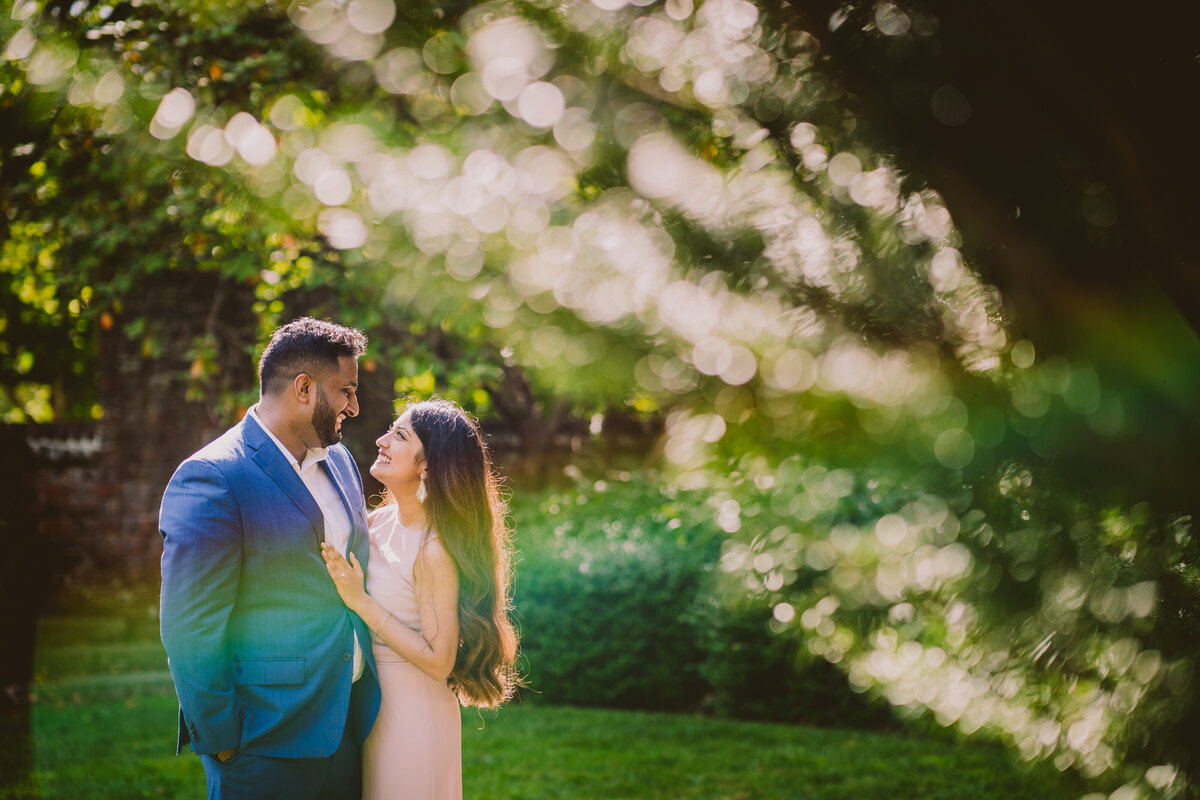A couple sharing a moment at the planting fields arboretum in long island ny