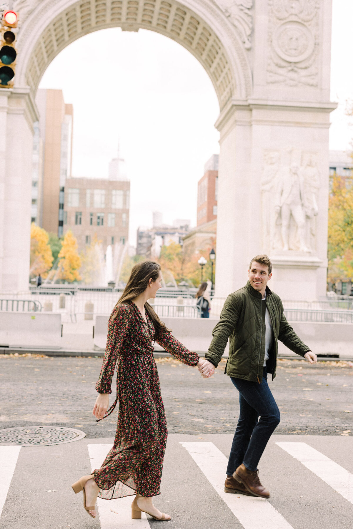 A couple taking a morning stroll through Washington Square Park in the West Village of NYC