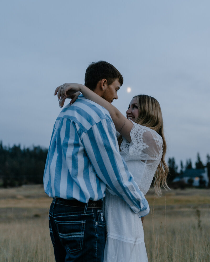 A couple embraces in a moody, cinematic couples session, featuring soft light and deep emotion in Washington.