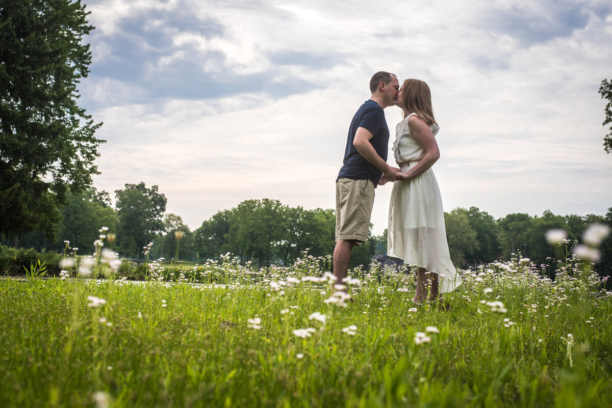 couple kisses in flower field portage lakes state park 