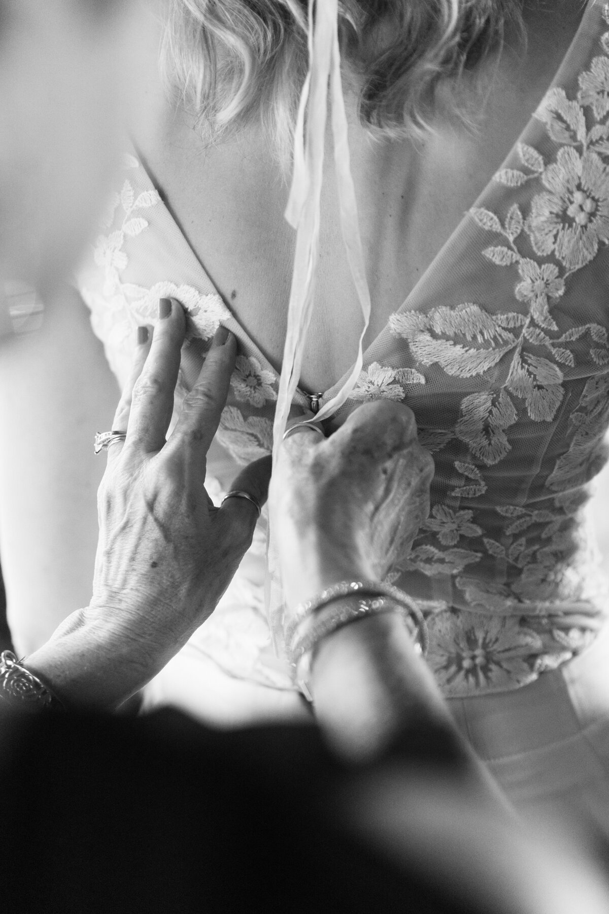 bride having back of dress pinned together