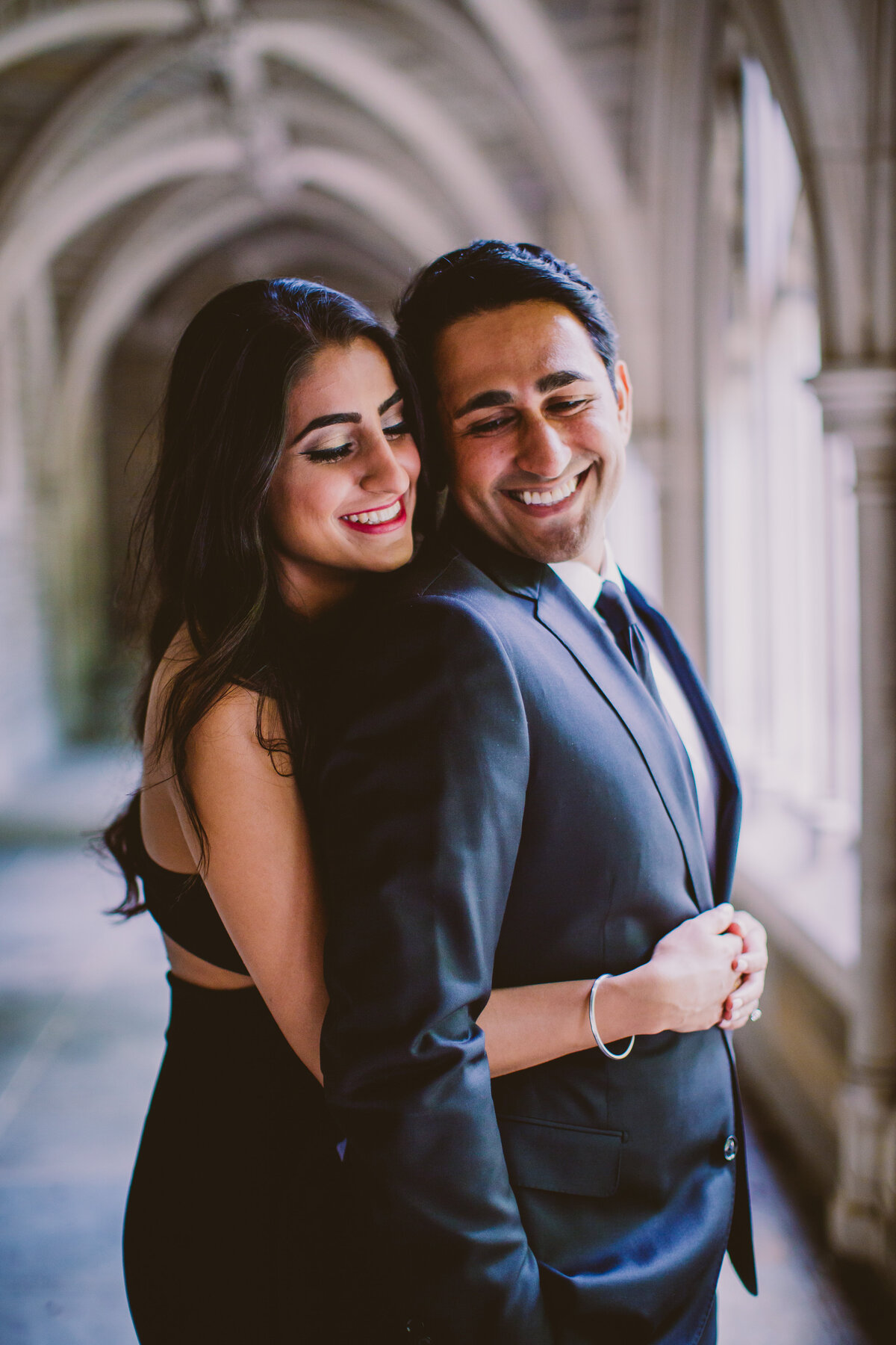 A couple sharing a moment inside a harry potter-esque hallway holder hall in princeton university nj