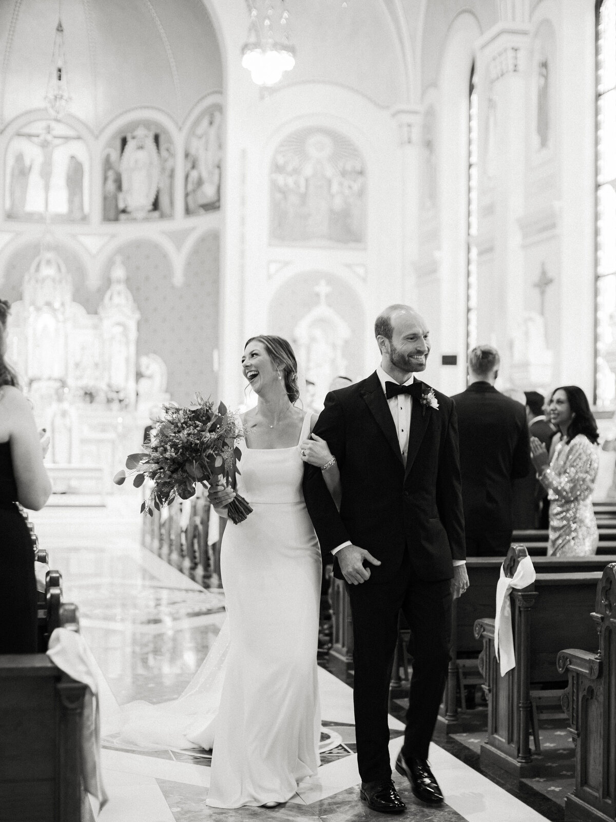 bride and groom exit from Sacred heart Peoria IL
