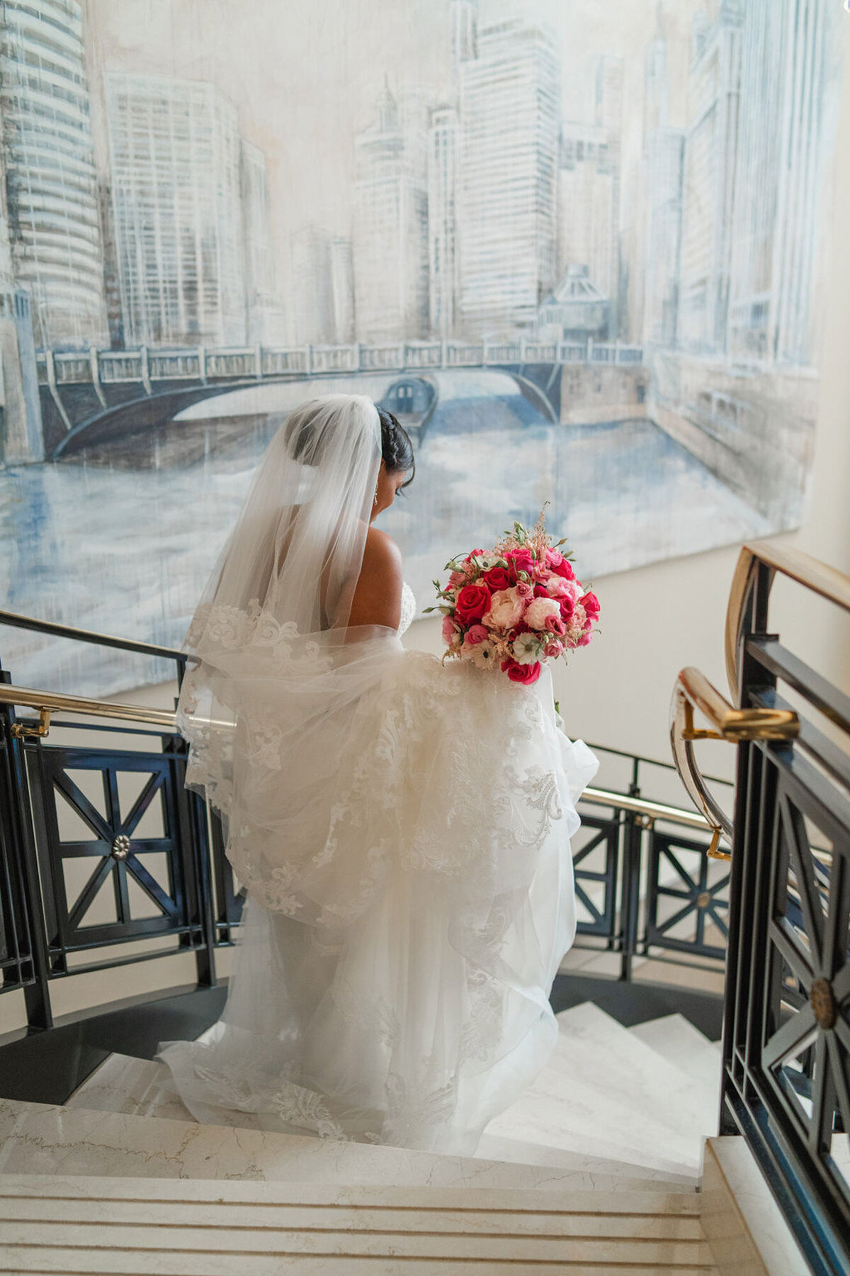 bride walking down staircase in downtown chicago