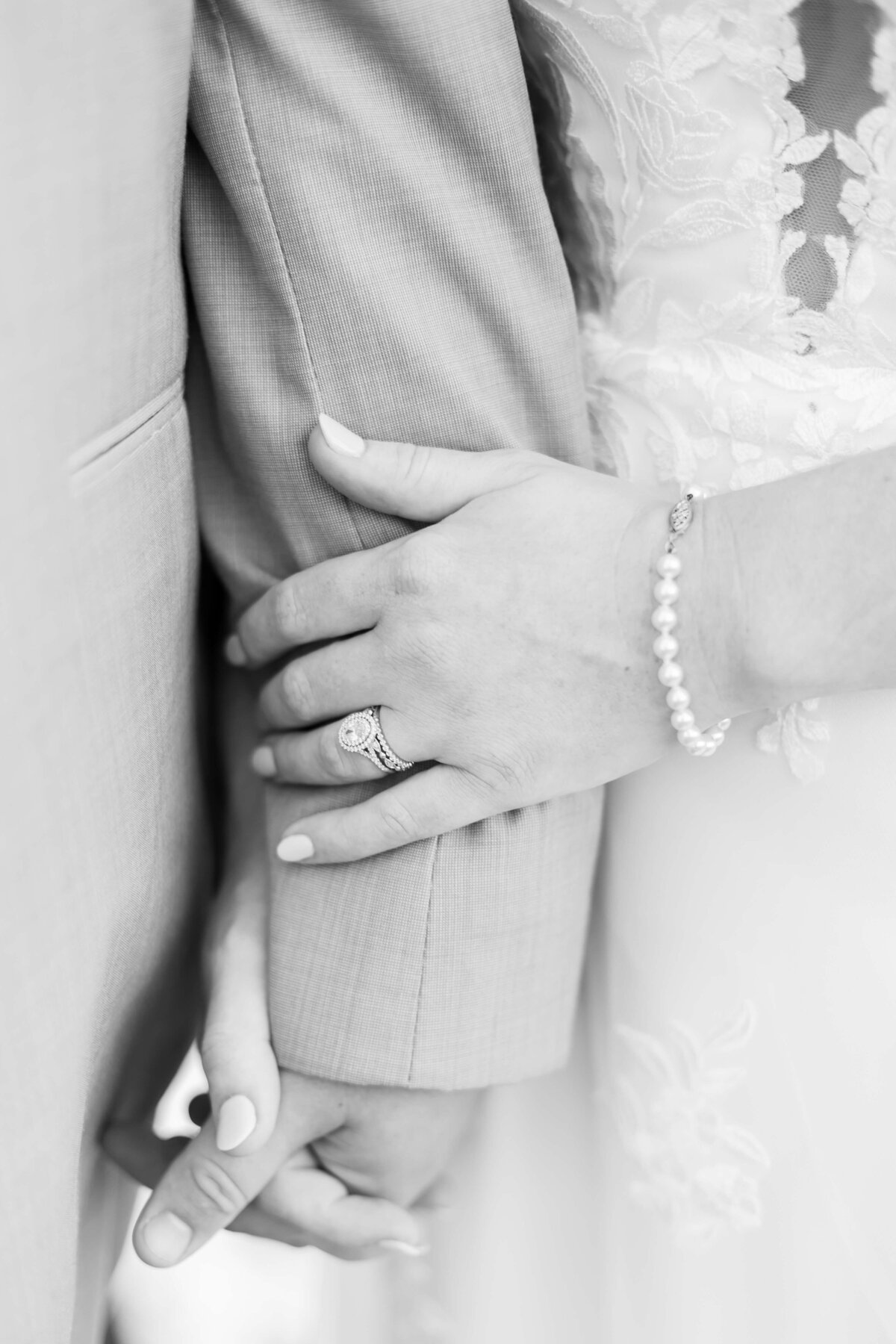 Close up of bride and groom holding hands