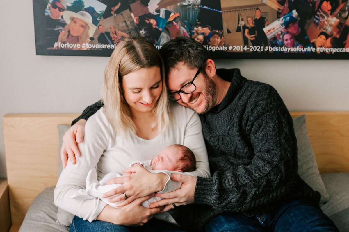 New parents hold their baby during their lifestyle newborn session