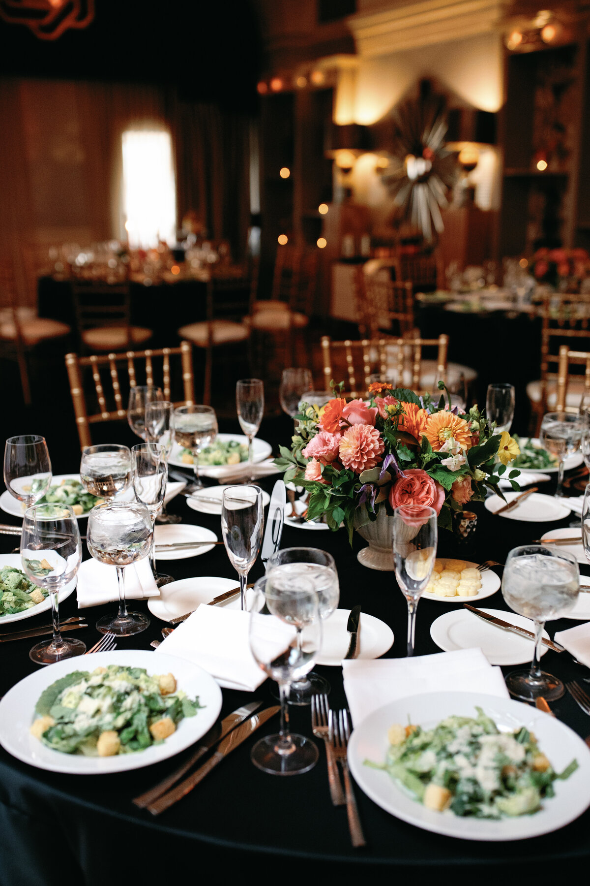 Hotel Monaco DC reception table with florals, candles, and elegant place settings.