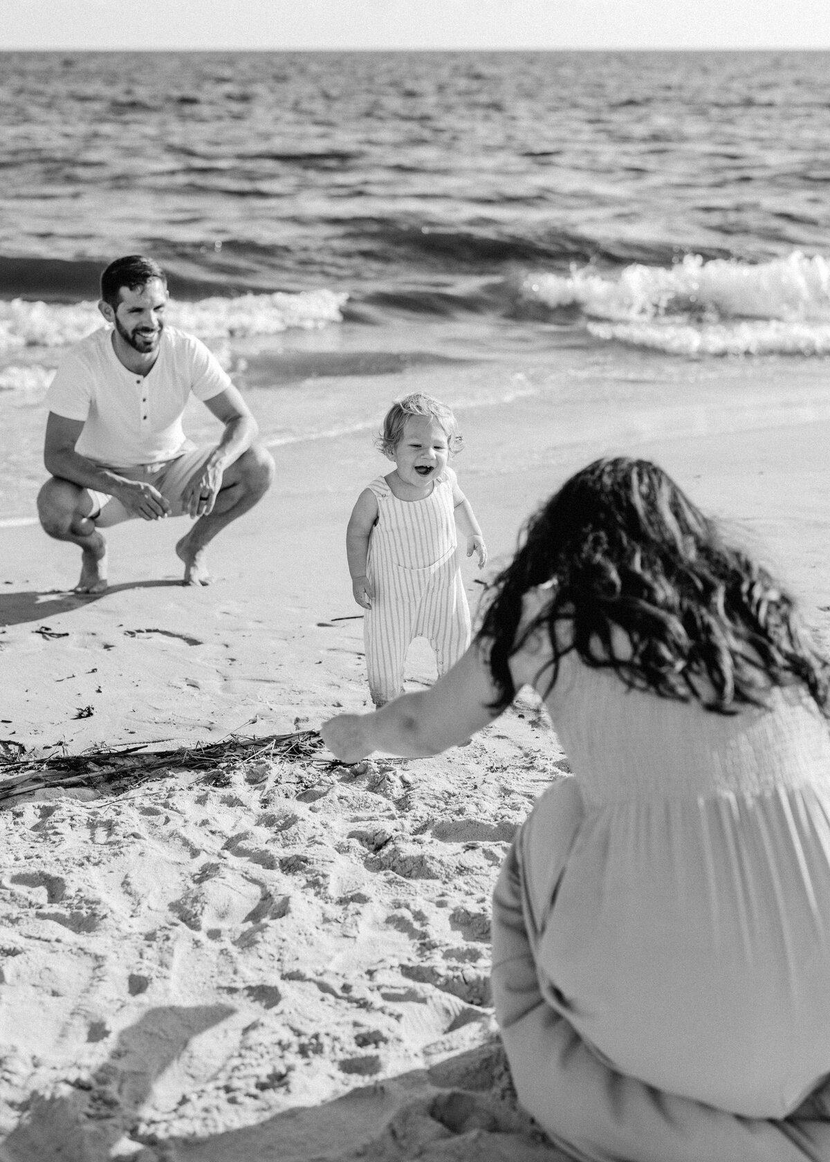 Happy family of four playing on Wrightsville Beach at sunset, Wilmington NC