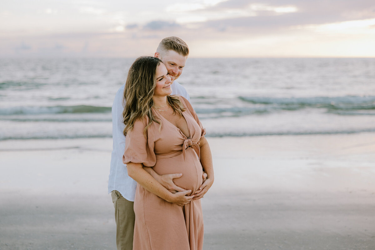 Pregnant couple on Clearwater beach for Tampa maternity photographer Tina Marie Studio.