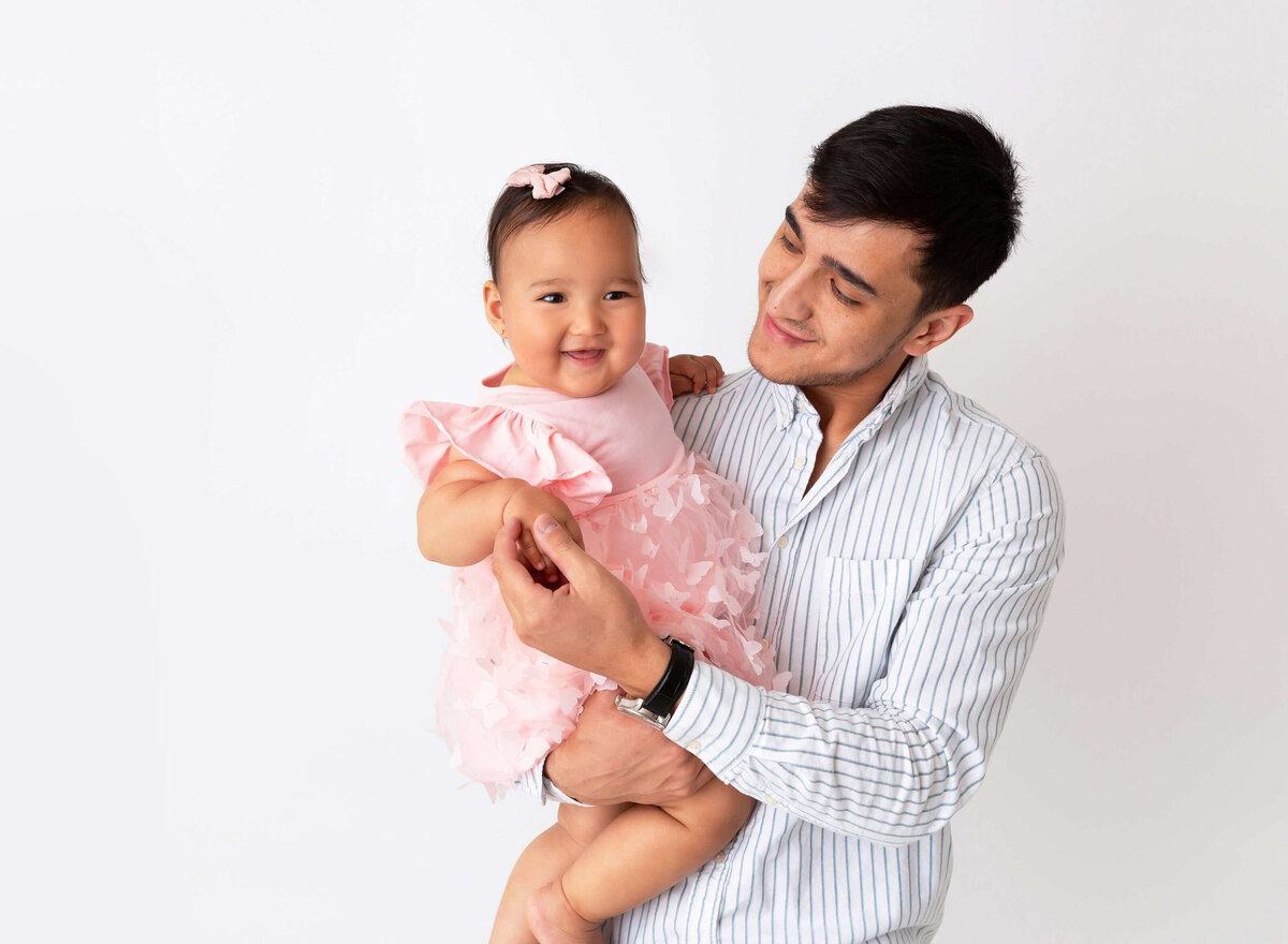 Father holding his baby girl for baby photoshoot in NYC 