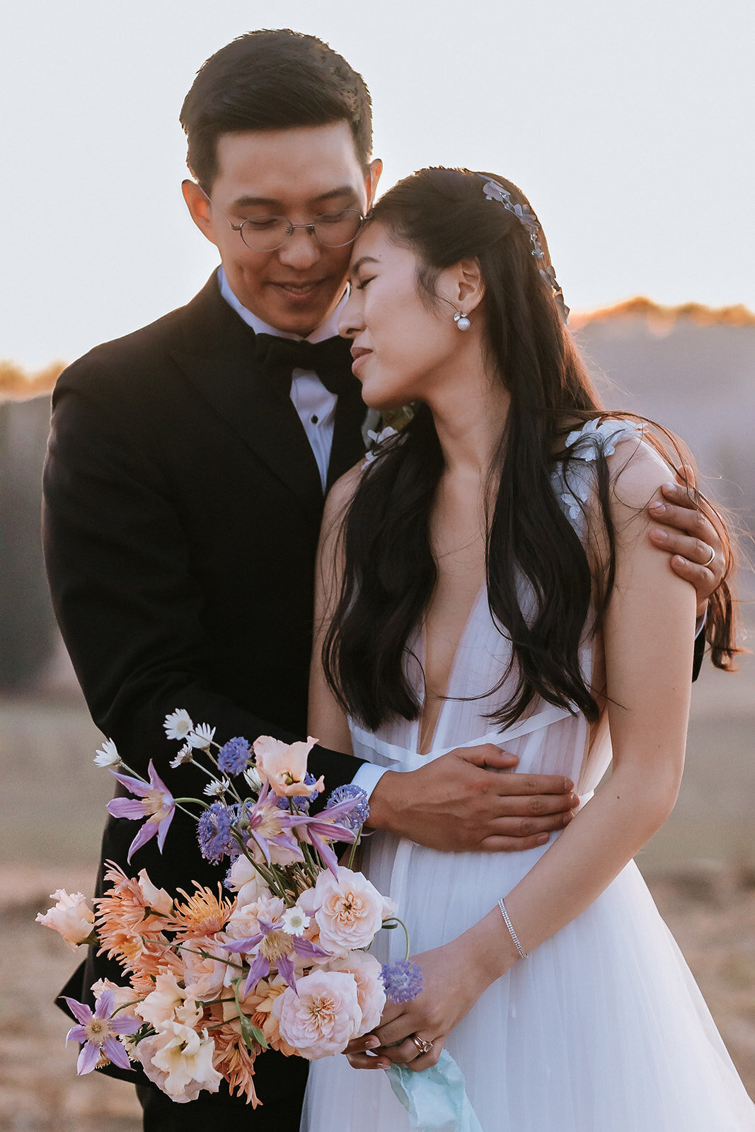 bride and groom with bouquet and boutonniere at olympias valley estate in napa with peach and lavender blooms
