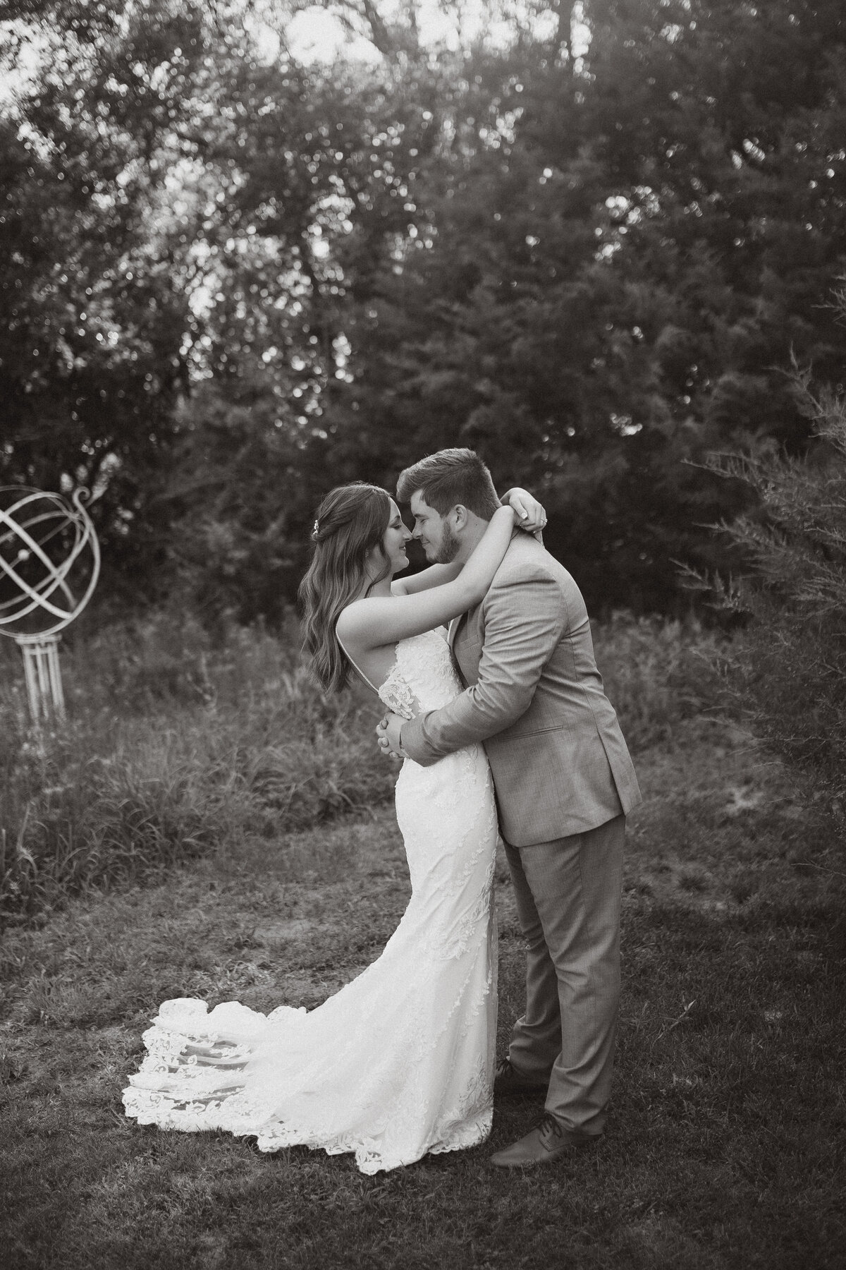 |Kansas Weddings| Affordable Weddings|Small Town Wedding Photographer|bride and groom about to kiss in field.