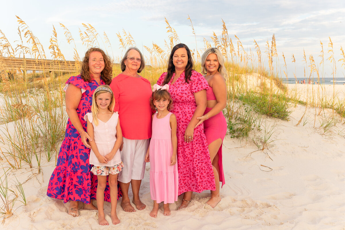 Ladies grop photo with grandmother in the middle with bright and colorful outfits