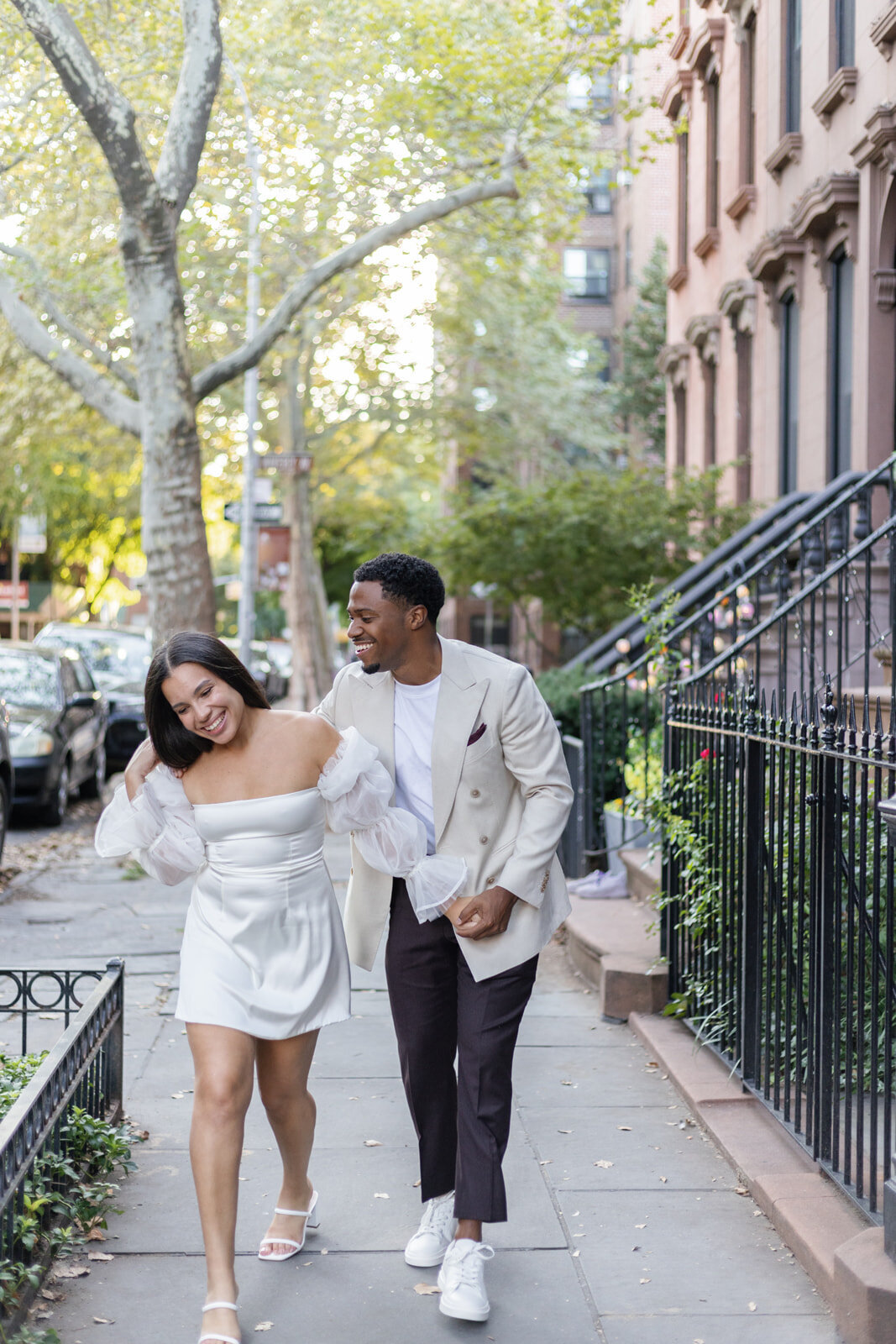 couple laughing and walking around brooklyn