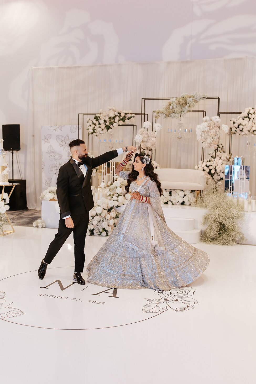 Bride and groom dancing at luxurious Indian wedding.