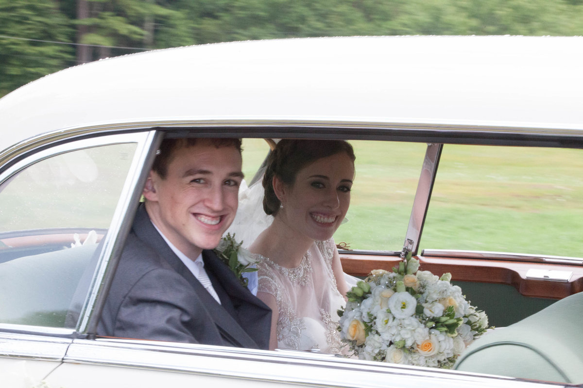 bride and groom in  a car
