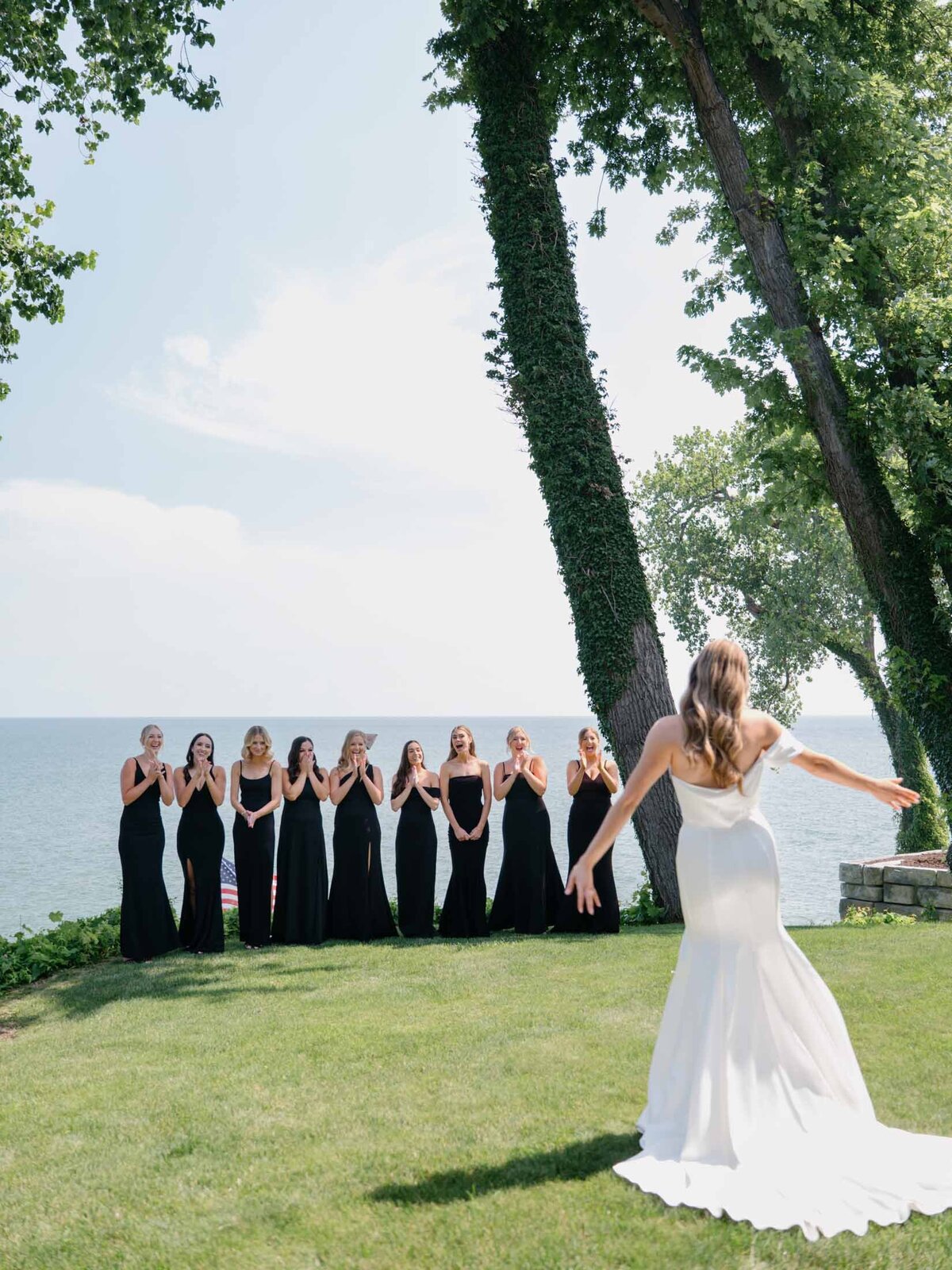 Bride's first look with her bridesmaids in front of Lake Erie