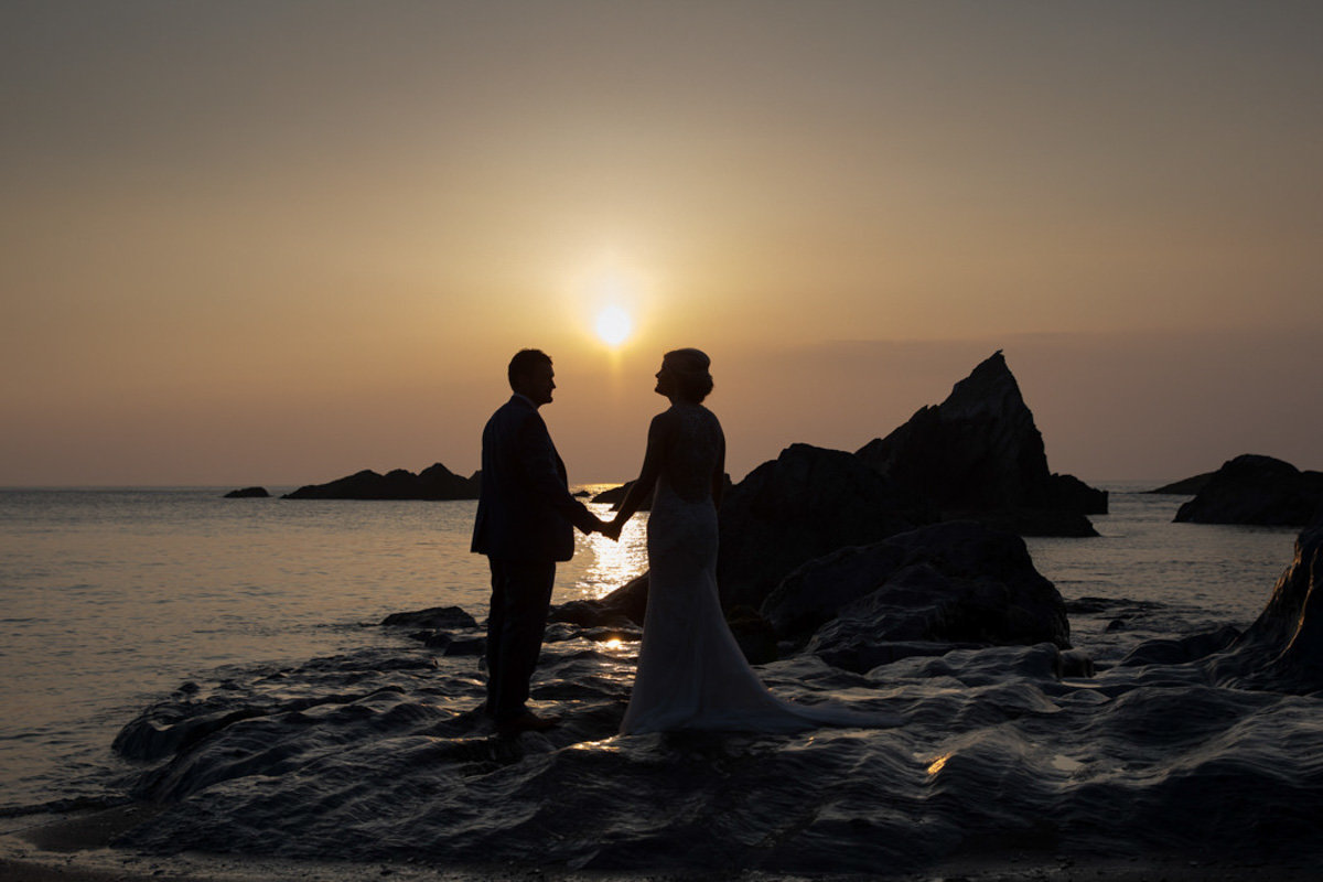 Silhouette at sunset on beach at Devon Beach Weddings Tunnels Beaches