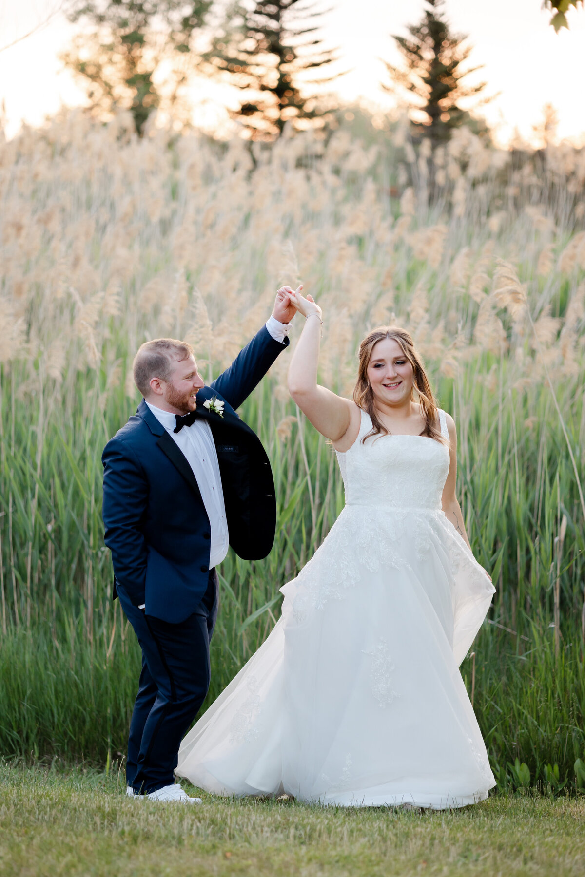 Bride and groom dance at sunset 