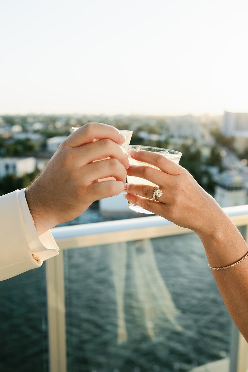 closeup of drinks and wedding ring on balcony at penthouse at riverside wharf​