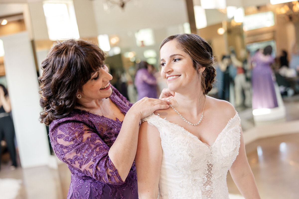 mother of bride in purple dress clasps necklace at Remi's Ridge Hidden Falls in Spring Branch Texas
