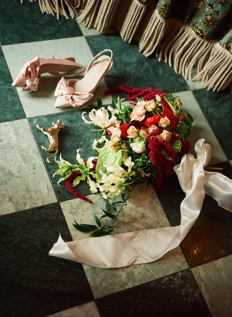 eclectic luxury flatlay with bouqet and shoes at lafayette hotel