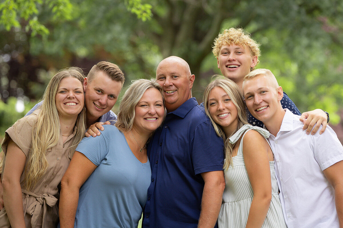 cute family with heads together looking at the camera