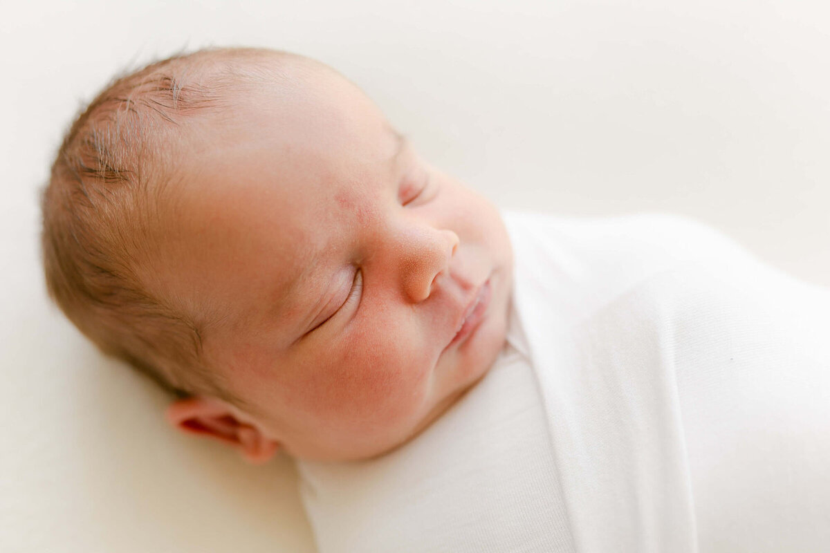Baby wrapped in neutral swaddle, captured by San Francisco Bay Area newborn photographer.