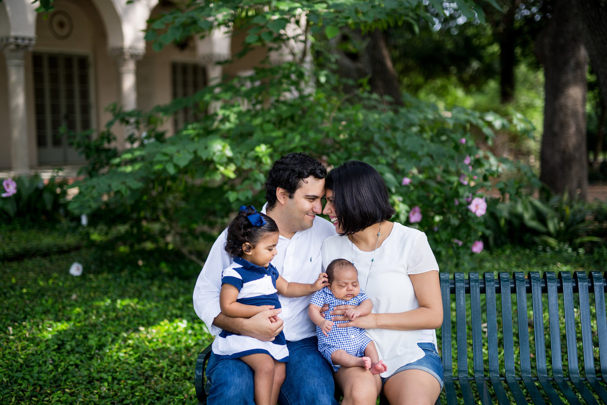 family portrait of couple sitting on bench with their four children by San Antonio photographer