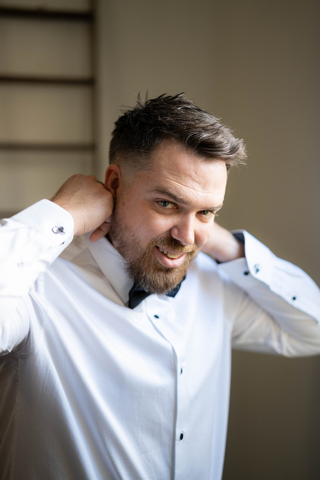 Candid moment of the groom getting ready