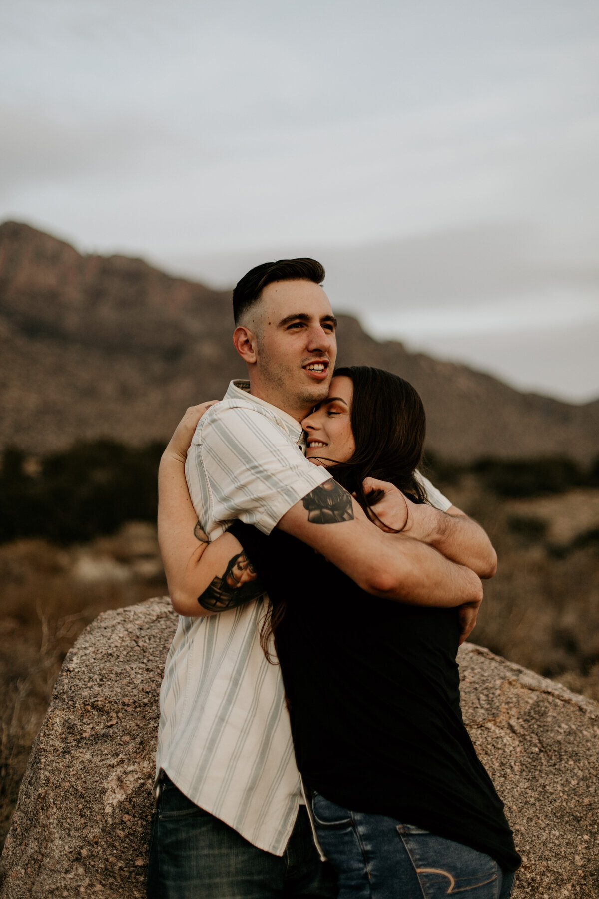 engaged couple hugging and smiling in New Mexico