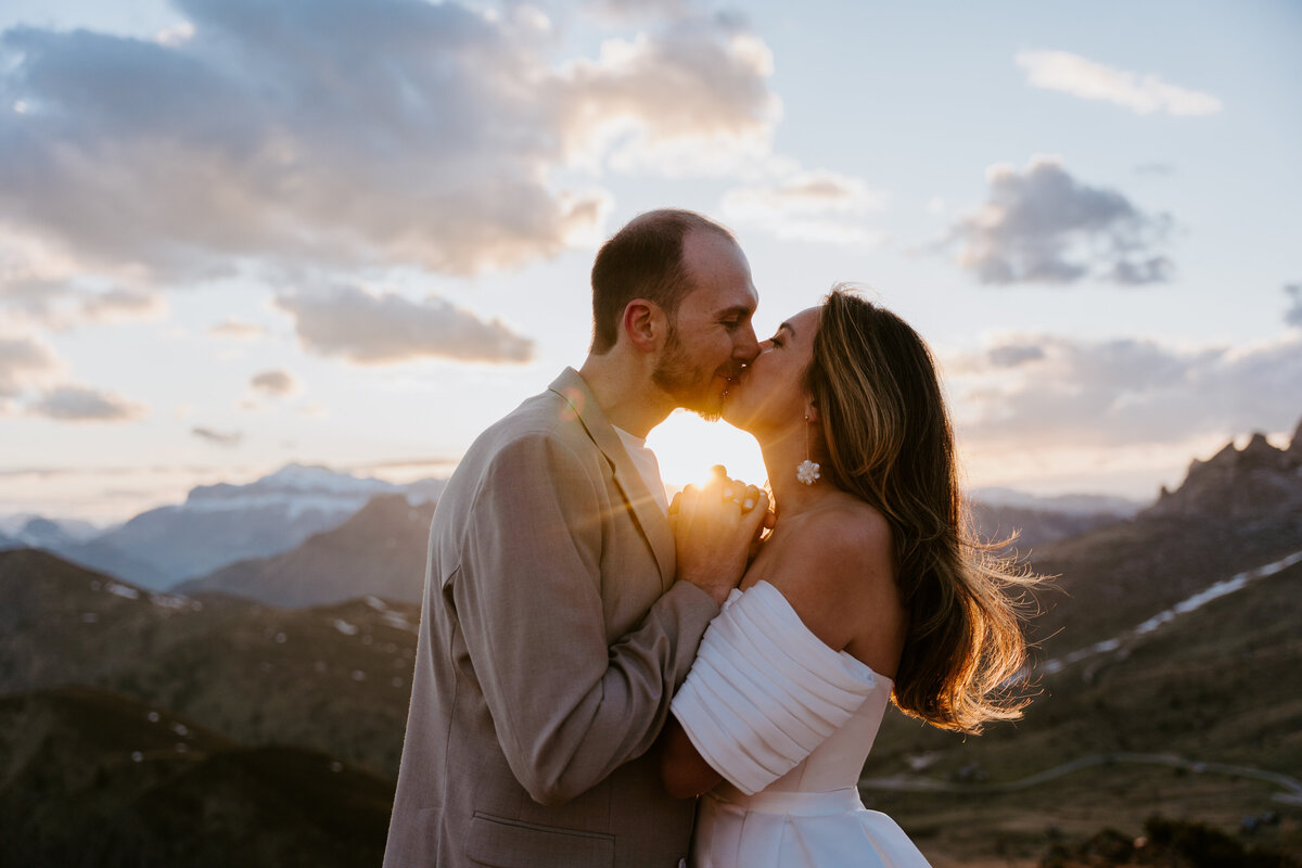romantic couple kissing during twilight elopement in Dolomites