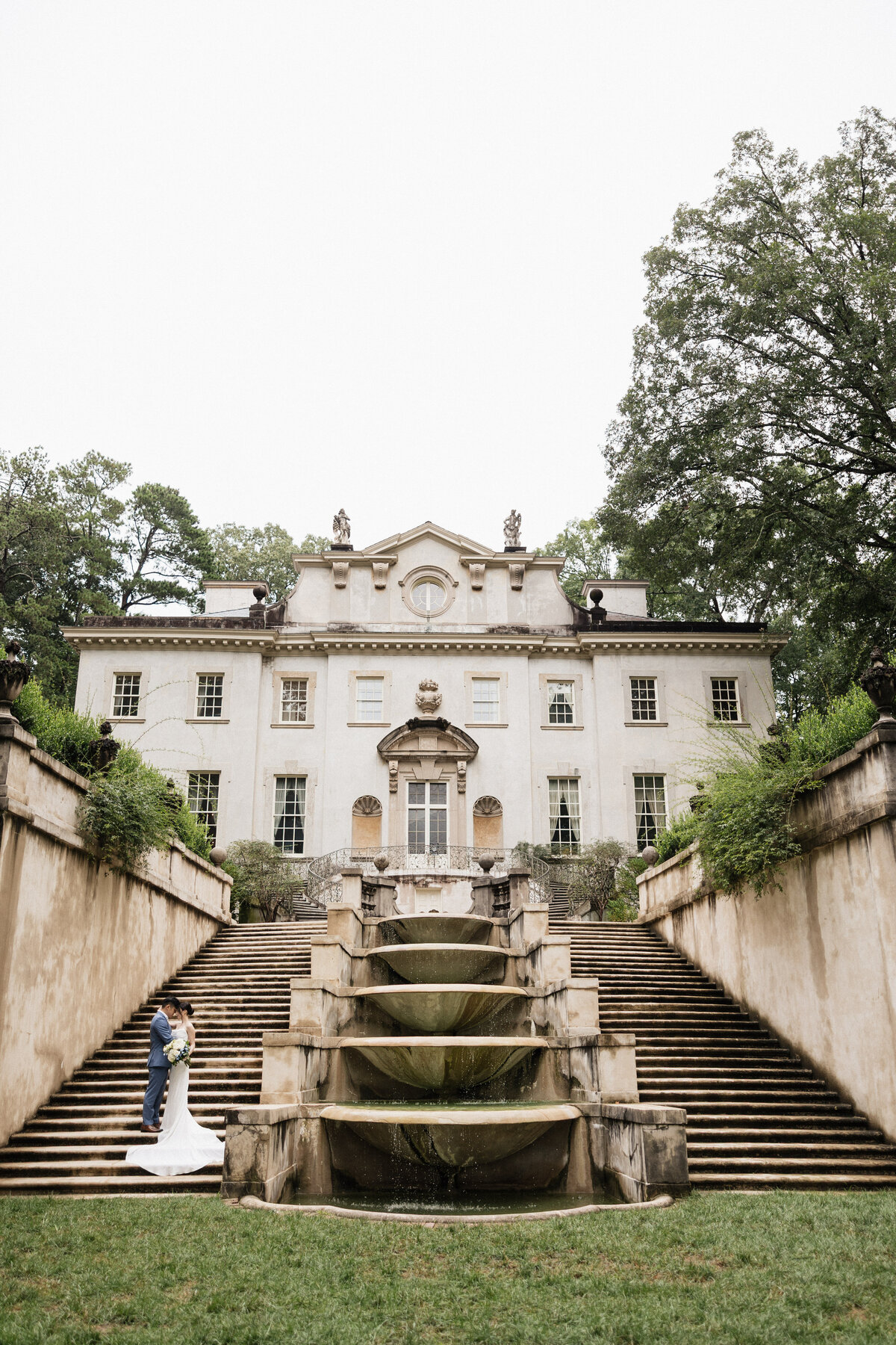 Swan house wedding with couple standing on the stairs.