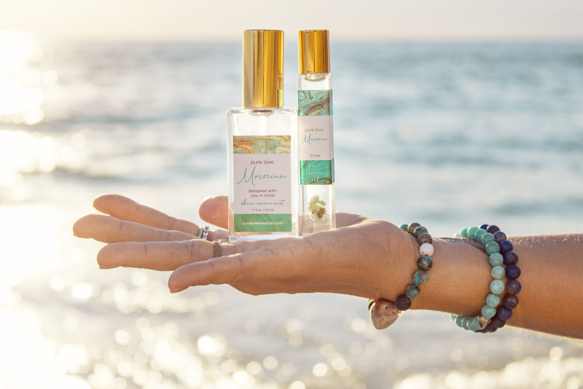 Model holds two perfume bottles for advertising photoshoot