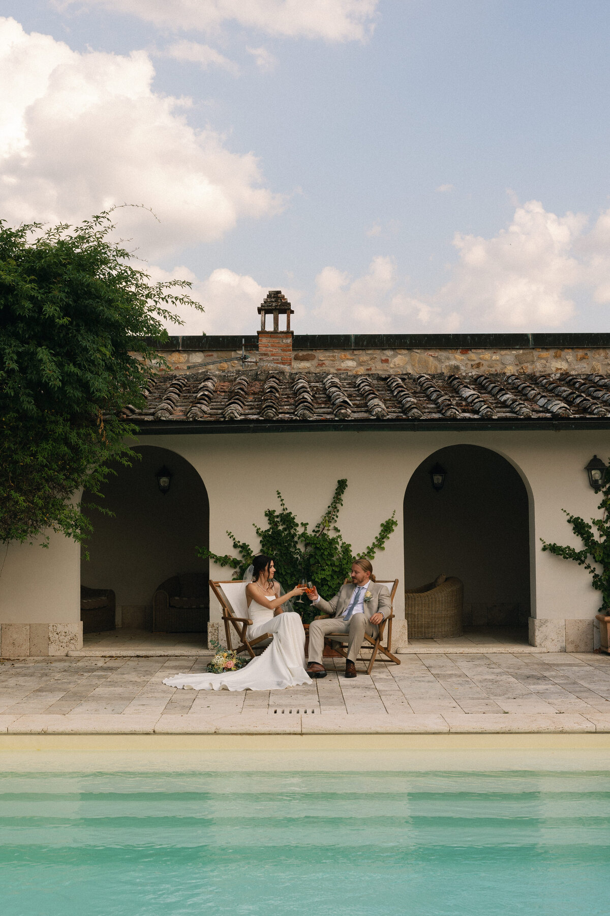 Couple enjoying Aperol spritz during portraits by the pool
