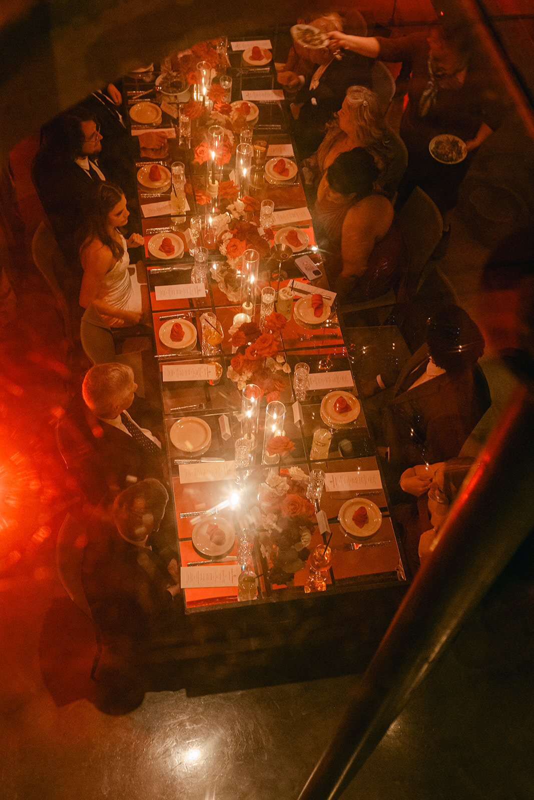 Dimly lit dinner ambiance with floral highlights at romantic San Antonio wedding venue
