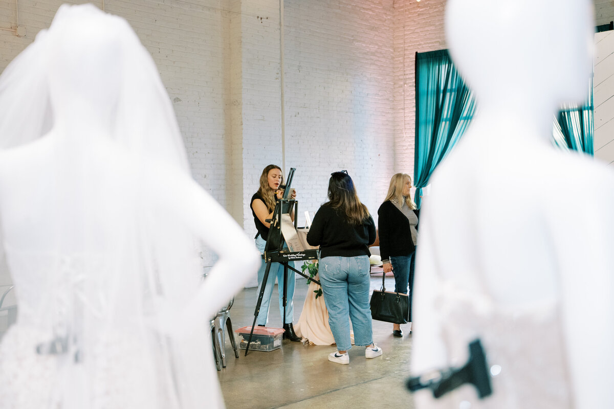 a behind the scenes shot of Olivia Andruss creating portraits for guests during an event at Skylight in Denver, Colorado.