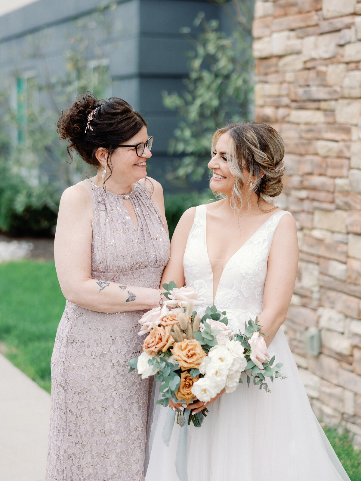 A bride and her mom share a touching moment as the bride gets ready for her wedding