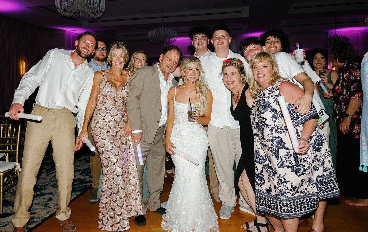Bride Brenda surrounded by family and friends, celebrating on the dance floor at her Cheeca Lodge wedding reception. Claudia Amalia Wedding Photography.