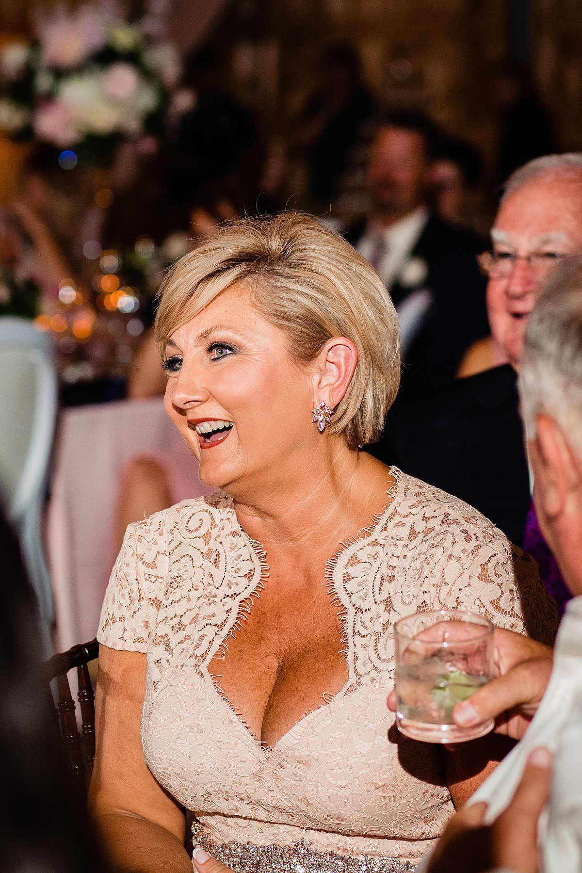 Mother of bride smiling during wedding toasts