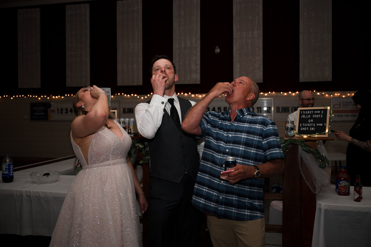 wedding couple doing shots with their guests