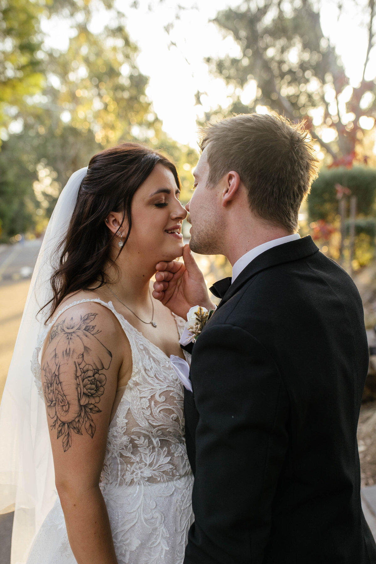 A soft kiss is shared between the bride and groom. 