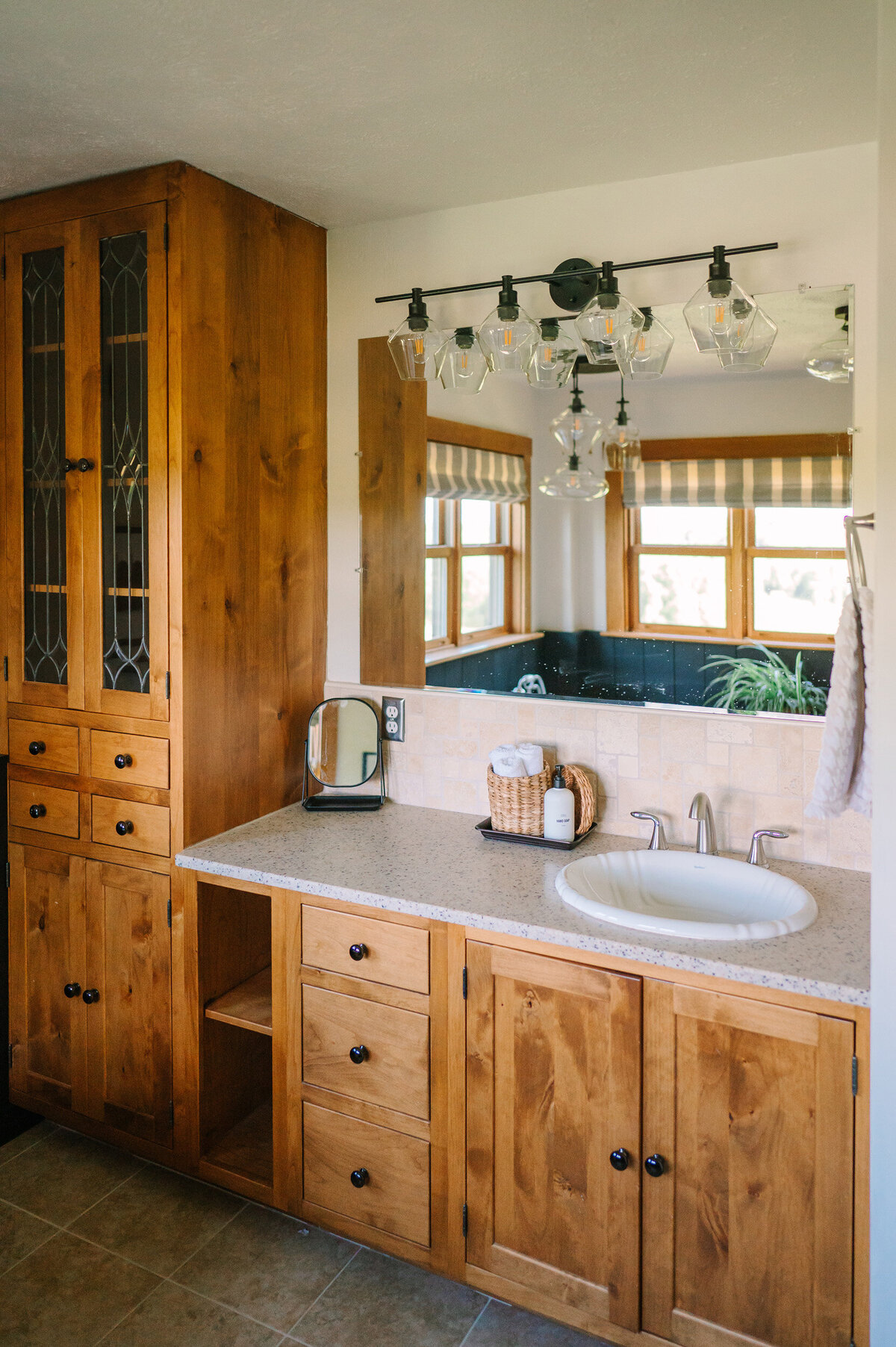 the second floor bathroom vanity with shell shaped sink and Pottery Barn vanity light in the modern farmhouse overnight accommodation at Willowbrook wedding venue